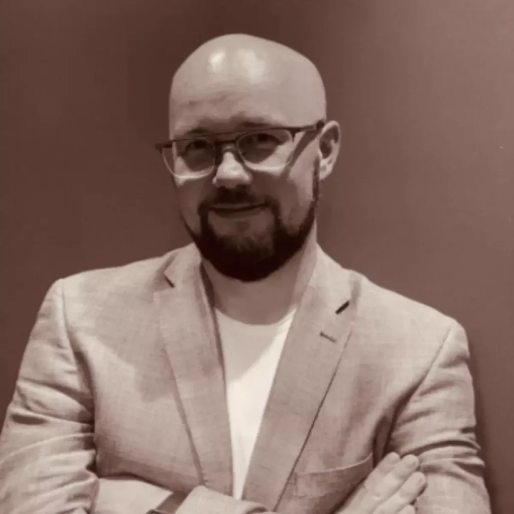 portret łysego mężczyzny w okularach i pięknym garniturze