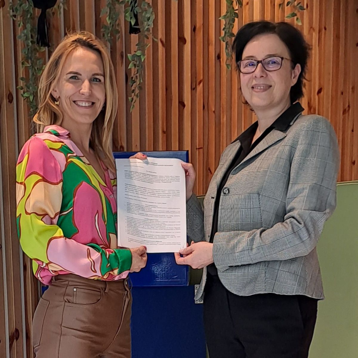 dwie kobiety na zdjęciu z dokumentem współpracy