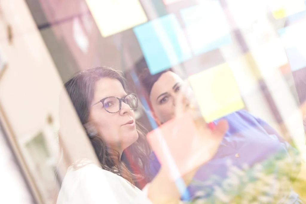 Dwie rozmawiające kobiety za szkłem