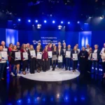 duza grupa ludzi z dyplomami i wyroznieniami na scenie podczas finalu gali plebiscytu Łaczy nas WIELkopolskie