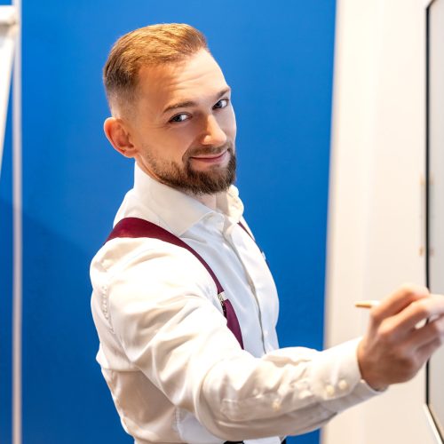 Mężczyzna w koszuli przy tablicy